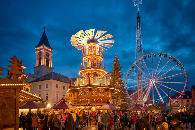 Christmas market on Karlsruhe's market square with mulled wine pyramid and Ferris wheel