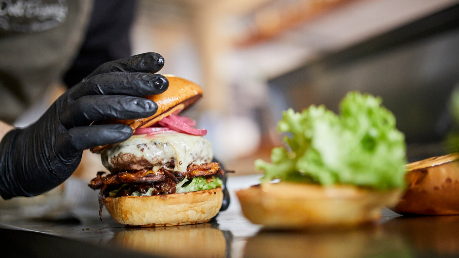 Préparation d'un burger juteux chez DeliBurgers à Karlsruhe